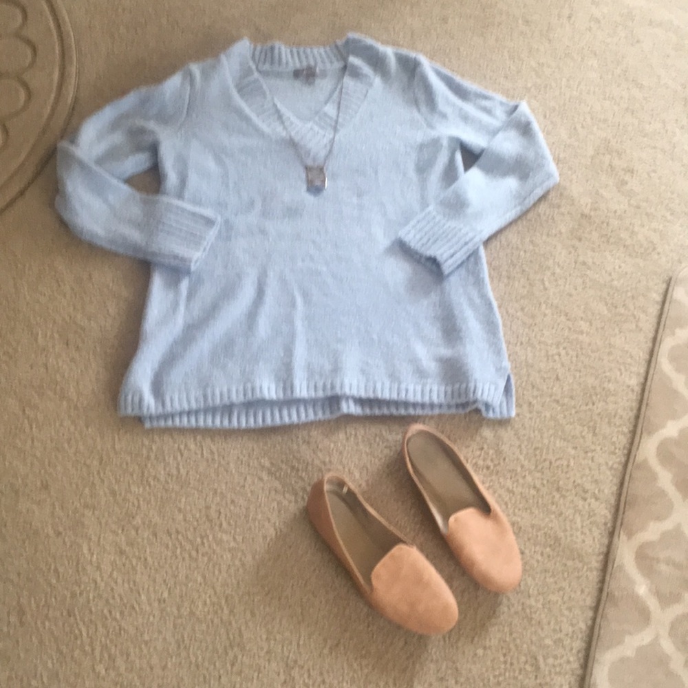 A light blue v- neck sweater.